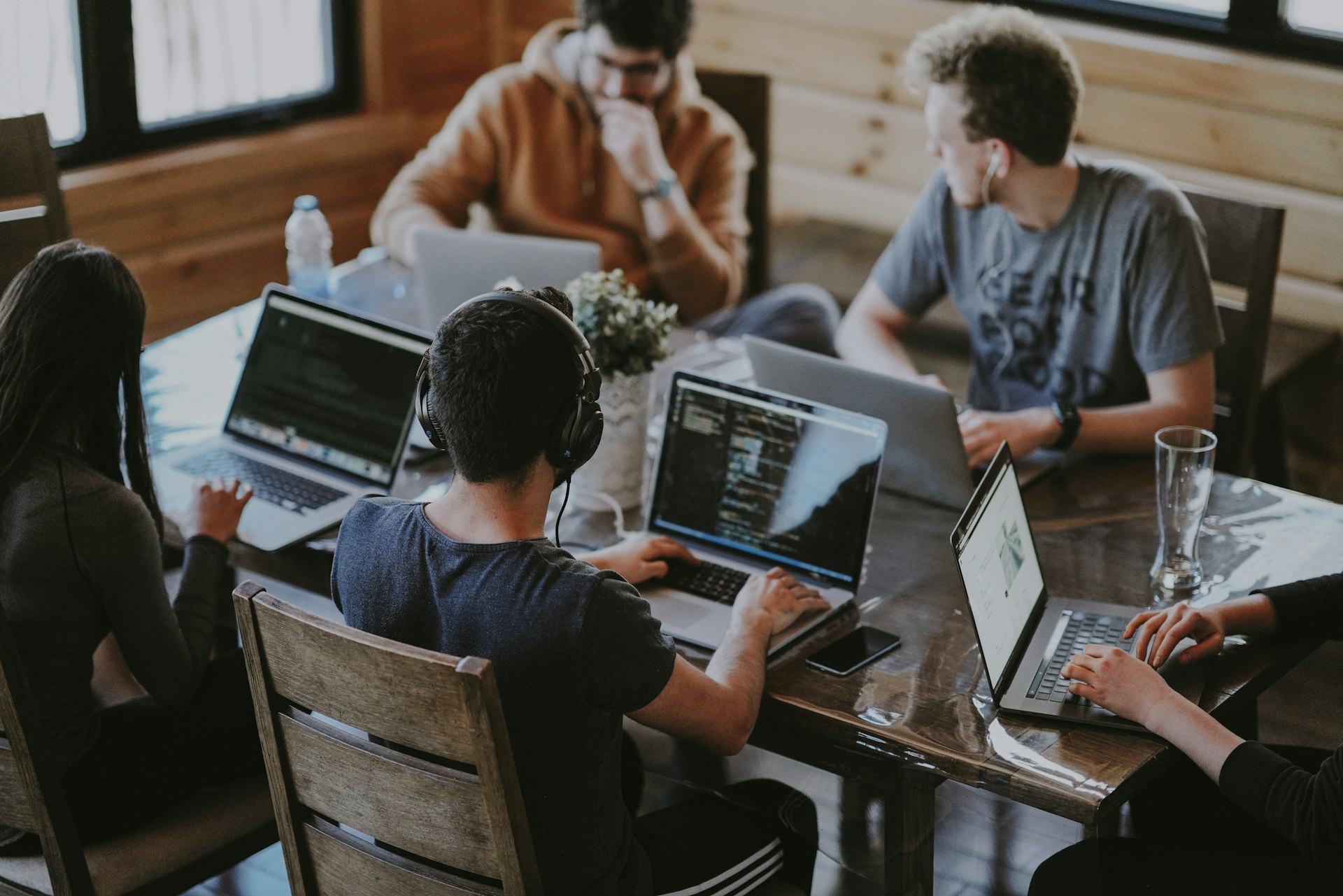 Team members collaborating at a table in a professional setting.