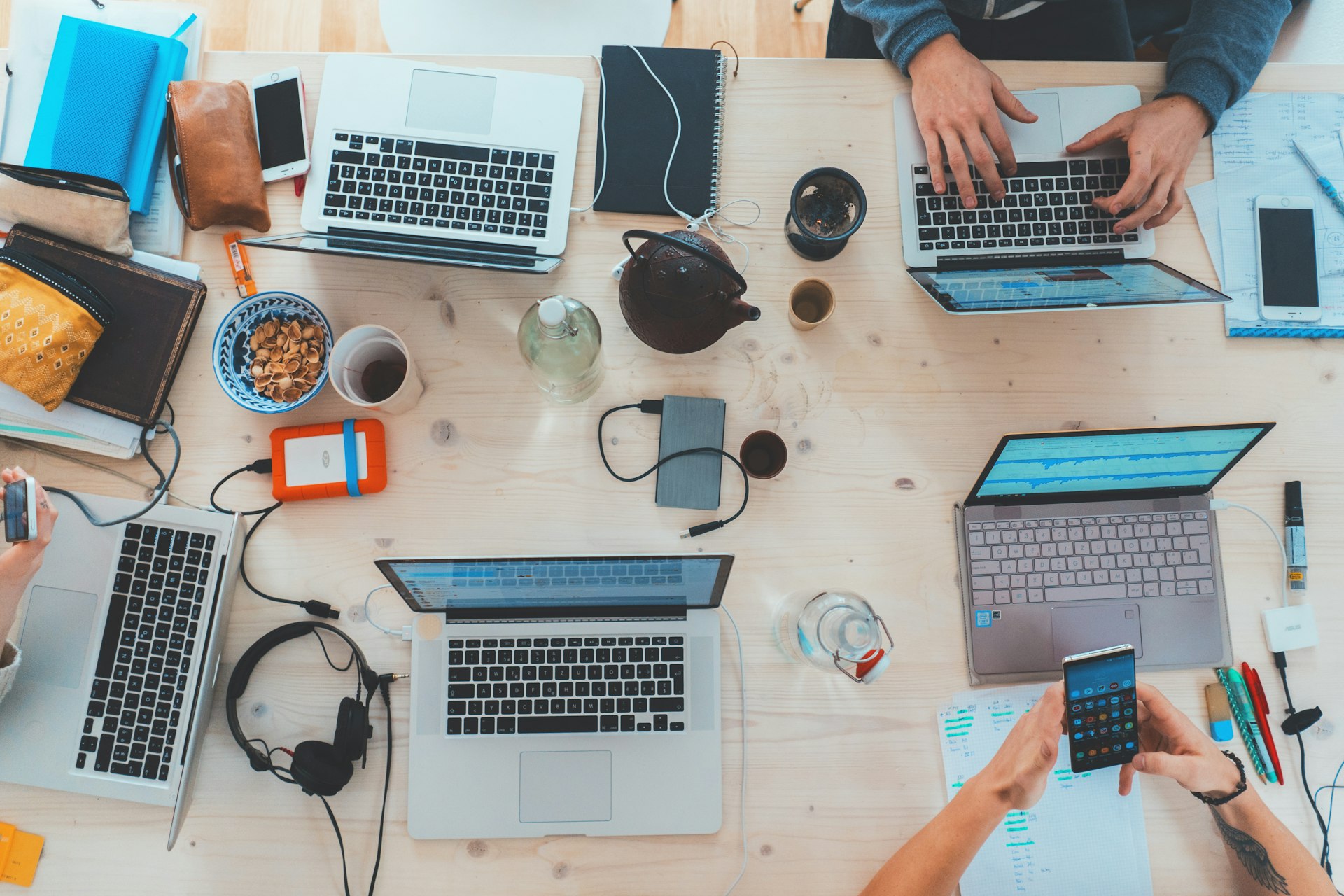 Professionals working together with laptops in a modern office.